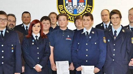 Stolz nahmen die Anw&auml;rter, flankiert von den Verantwortlichen der Feuerwehr, ihre ihre Abzeichen entgegen.  Foto: Ingrid Kohles