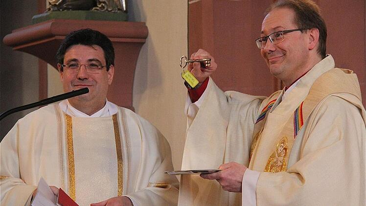 Amtseinführung: Dekan Michael Krammer (links) übergibt Pfarrer Thomas Eschenbacher die Schlüssel für die Kirche. Fotos: Gerd Schaar