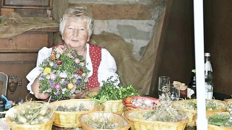 Lisbeth Baier flocht passend zum Feiertag Kränze aus Kräutern.