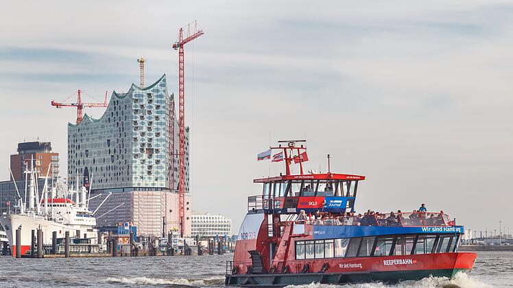 Construction of the landmark Elbe Philharmonic building rises behind public harbor ferry "Reeperbahn"  in Hamburg, Germany on March 20, 2014. Der Bau des markanten Elbphilharmonie-Gebäudes hinter der öffentlichen Hafenfähre „Reeperbahn“ in Hamburg, Deutschland, am 20. März 2014.