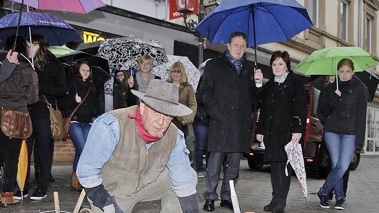 Der K&ouml;lner K&uuml;nstler Gunter Demnig setzte gestern Nachmittag  die  Kulmbacher "Stolpersteine". Die erste pflastersteingro&szlig;e Messingstafel versenkte Demnik in der Langgasse vor dem Gesch&auml;ft von Hermann Aberle im Boden. Aberle wurde wegen "Wehrkraftzersetzung" angeklagt und 1944 gehenkt. Foto: Dagmar Besand