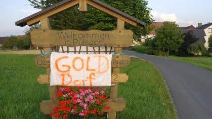 Die Pülsdorfer zeigen der Welt, was sie seit vergangener Woche sind: ein Gold-Dorf! Fotos: Berthold Köhler