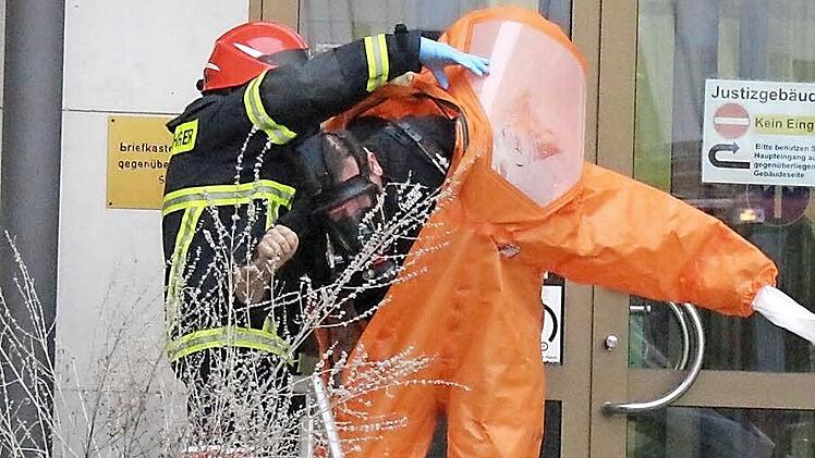 Verstörendes Bild vom 11. Januar: Ein Feuerwehrmann schält sich mit Hilfe eines Kollegen aus einem Schutzanzug. Die Feuerwehr musste unter diesen Sicherheitsvorkehrungen im Coburger Justizgebäude den Umschlag bergen, der weißes Pulver enthielt.  Foto: Simone Bastian/CT-Archiv