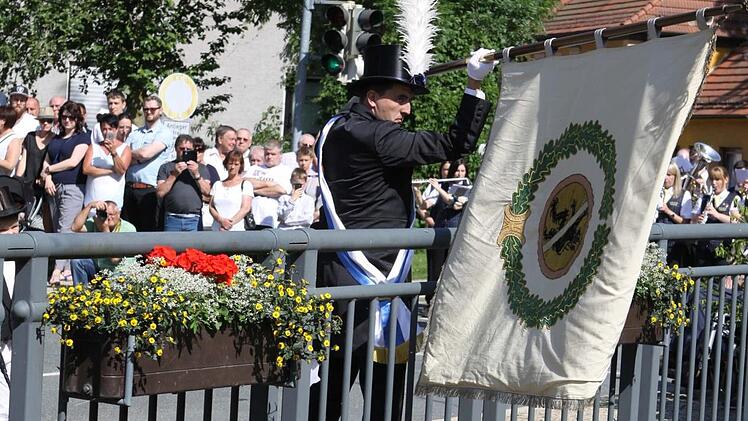 Matthias Zeitler schwenkte in diesem Jahr erstmals als jüngstes Stadtratsmitglied die Fahne an der Schwedenbrücke. Foto: Michael Wunder