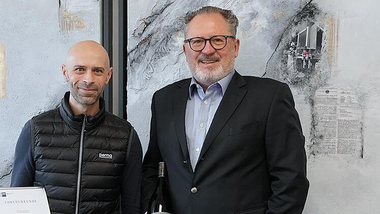 Im Namen der Gesch&auml;ftsleitung gratulierte Peter Mayr (rechts) und &uuml;berreichte Marco Eilingsfeld als Zeichen der Wertsch&auml;tzung die IHK-Ehrenurkunde sowie ein Pr&auml;sent.