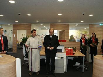 Nach einem umfassenden Umbau eröffnete gestern die Knetzgauer Sparkassen-Filiale wieder ihre Türen. Den kirchlichen Segen spendeten Pastoralreferent Volker Krieger und Pfarrer Hans-Christian Neiber, beobachtet vom Vorstandsvorsitzenden der Sparkasse Ostunterfranken Peter Schleich (links) und den Kundenberaterinnen Irene Leis, Katharina Kraus und Kathrin Pfennig. Fotos: Sabine Weinbeer