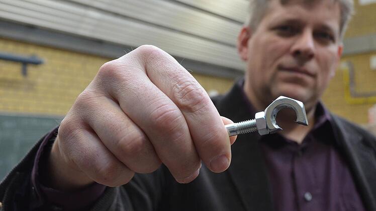 Martin Flohrschütz zeigt, wie der Flaschenöffner am Ende aussehen soll, den die Teilnehmer bauen müssen.