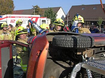 Unter Beachtung der eigenen Sicherheit trennen Feuerwehrleute mit einem Rettungsspreizer die Dachkonstruktion vom Fahrzeug. Foto: Klaus Oelzner