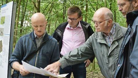 Ralf Obst (Landesamt für Denkmalpflege), Bürgermeister Armin Warmuth, Holzrechtler Waldemar Hauk und Kreisheimatpfleger Roland Heinlein betrachten den neu erstellten Lageplan. Foto: Elisabeth Assmann