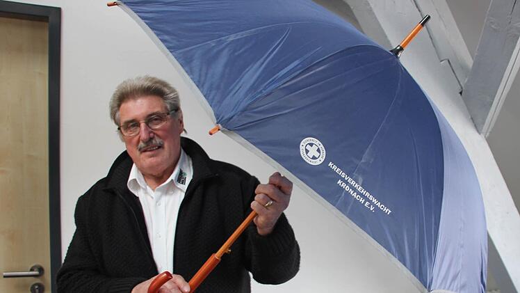 Roland Pyka mit dem Verkehrswacht-Regenschirm. Der sieht nicht nur elegant aus, sondern reflektiert auch Scheinwerferlicht. Die Reflektoren sind farblich dezent.  Foto: Friedwald Schedel