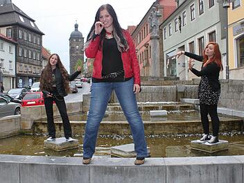 Musikerinnen mit Sinn für Humor: Für ein Foto steigen Stefanie Hauber (links), Anna Rosenfeld und Jana Efremova (rechts) in den Floriansbrunnen und spielen Luftbass - oder Luftvioline. Foto: Markus Häggberg