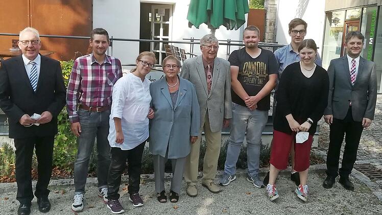 Die Jubilarin Edeltraud Krauß (Vierte von links ) mit Ehemann Erich (rechts daneben) und den Enkelkindern (v.l.) Mario, Lisa, Lukas, Niclas und Jette. Es gratulierten ebenso Erster Bürgermeister Harald Hübner (links) und Pfarrer Johannes Feldhäuser (rechts).