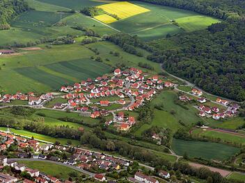 Annähernd 400 Bürger leben im Eberner Baugebiet Mannlehen. Die Bewohner fordern seit Jahren den Bau einer zweiten Zufahrt außer der Anbindung an die Straße Richtung Gleusdorf. Die Luftaufnahme aus Richtung Nord-West stammt aus dem Jahr 2012.Ronald Rinklef