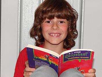 Tim Walter, der 500. registrierte Leser in der Gemeindebücherei im KOMM in Untermerzbach, liebt die Geschichten der Gänsehaut-Kinderbuchreihe.  Foto: Johanna Eckert