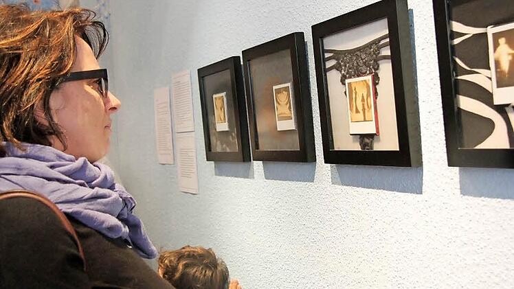 Ausstellung: Silvie Scherpf, selbst Künstlerin, betrachtet Collagen von Ramin Parvin. Fotos: Angelika Silberbach