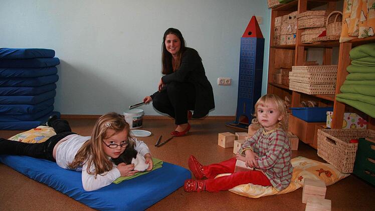Gruppenleiterin Miriam Kapfhammer und die beiden Kinder Lisa Thum (4) und Mylene Kerriel (3) finden  die Neugestaltung prima: Das Träumeland hat einen Korkboden bekommen, und die Wände wurden in zartem Blau gestrichen. Fotos: Sonja Adam