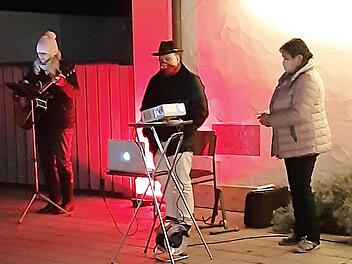 Ganz in Licht getaucht singen und beten sie vor dem Pfarrhaus. Von links Silvia Wachter, Pfarrer Richard Reis und Kornelia Ströhlein  Foto: Susanne Deuerling