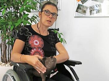 Nadine hat das Spendenschwein von Gabis Tagespflege auf dem Schoß. Sie hofft, dass am Tag der offenen Tür möglichst viele Menschen etwas in das Sparschwein geben.  Foto: Jennifer Hauser