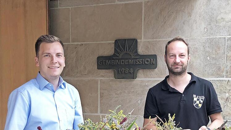 Das Bild zeigt die Vereinsmitglieder Jonas Stirnweiß (links) und Martin Sponsel beim Verteilen der Sträuße.
