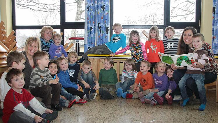 Die Kinder des Kindergartens in Grub am Forst lauschen Yvonne Rose (rechts) und der kleinen Raupe Nimmersatt.  Fotos: Thomas Heuchling