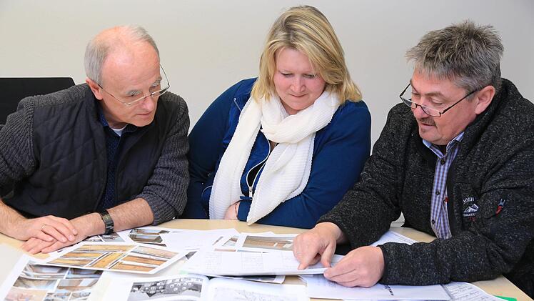 Bürgermeister Markus Grüner mit Bianca und Jürgen Häfner beim Studieren alter Unterlagen Foto: Franz Galster