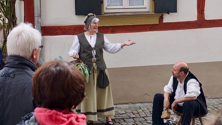 Edith Jager als Bürgerin fragt den Zimmermann, gespielt von Hansi  Homburg, über sein Handwerk aus.   Foto: Tina Meier