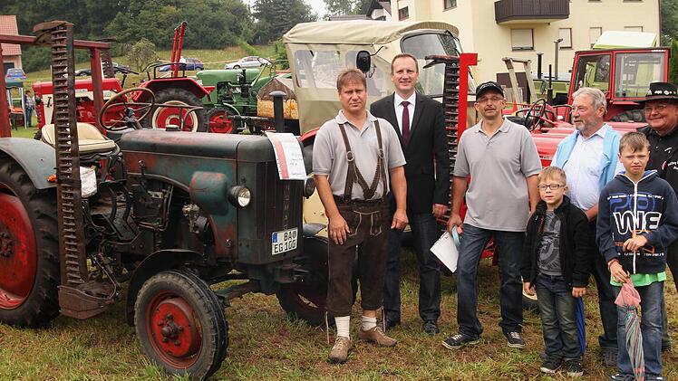 Die Brüder Thomas Graser (links) und Artur Graser (Dritter von links) stehen an der Spitze der "Bulldog-Freunde Lembach" und zeigen hier Schirmherrn Bürgermeister Michael Ziegler (Zweiter von links) alte Veteranen wie den Hanomag R 16 aus dem Jahre 1956.