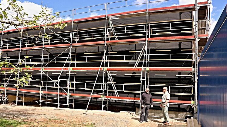Noch ist das neue Gebäude des Wohnheims der Schreinermeisterschule in Ebern verhängt, und es ist nur wenig zu sehen, wie es künftig einmal aussehen wird. Hier ist Schulleiter Oliver Dünisch (rechts) im Gespräch mit einem Arbeiter.Helmut Will