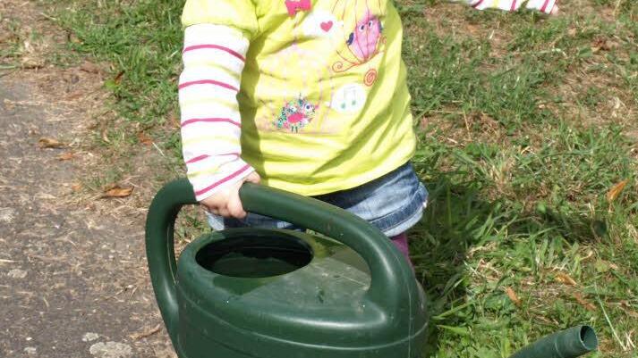 Die kleine Amelie Kremer will "ihrem" Baum Wasser geben.