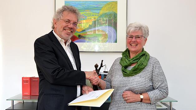 Bad Kissingens Amtsgerichtsdirektor Reinhard Oberndorfer &uuml;berreichte Brigitte Zecha die Freistellungsurkunde. Fast 30 Jahre war sie als Angestellte am Amtsgericht t&auml;tig.  Foto: Peter Rauch
