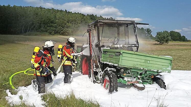 Mittels Schaumangriff unter schwerem Atemschutz wurde der Traktor abschließend komplett gelöscht.  Foto: Feuerwehr Heroldsbach/Thurn