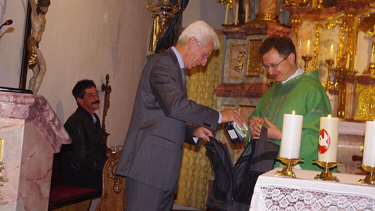 Kirchenpfleger Roland Pompe beschenkte Pater Jan Poja zum Abschied mit einem Rucksack und einer Notfall-Box.   Fotos: Schülein