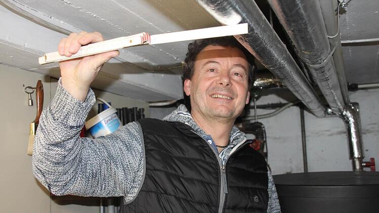 Dieter Spaderna misst die Dämmstärke der Rohrleitungen. Diese im kalten Keller zu isolieren, empfiehlt er dringend. Die Isolierschalen - hier bei einem Nachbarn des Energieberaters in Oberbrunn passend angebracht - sind nicht teuer, helfen aber viel.  Foto: Andreas Schmitt