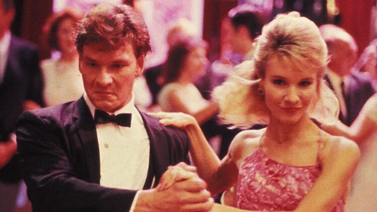 Cynthia Rhodes (Bild, mit Patrick Swayze) hatte bereits in den Tanzfilmen "Flashdance" (1983) und "Staying Alive" (1983) ihr K&ouml;nnen gezeigt. In "Dirty Dancing" spielte sie Penny Johnson, eine T&auml;nzerin des Resorts, die unerwartet schwanger wird und f&uuml;r die "Baby" einspringt.