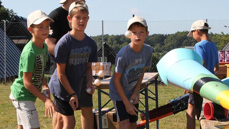 Kevin (von links), Finn und Phil versuchen sich im Ping Pong Golf. Dabei werden Tischtennisbälle mit der Hand in eine Röhre geworfen, die die Kinder eigens dafür gebastelt haben. Foto: Ulrike Müller