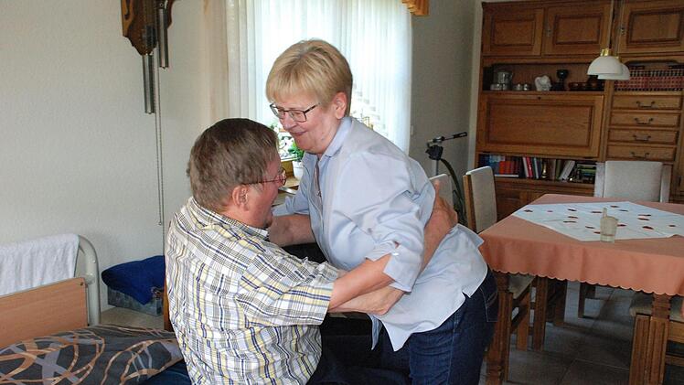 Schwerstarbeit: Gisela Dötschel hebt ihren Mann Gerhard ins Bett.Christiane Lehmann