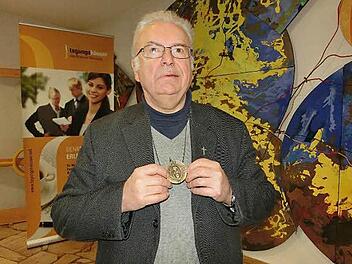 Pallottiner-Pater Gottfried Scheer zeigt das Begleitstück auf seinem Lebensweg: eine Medaille mit dem Gesicht Jesu vom Turiner Grabtuch. Der Geistliche, der aus Oberfranken stammt, erläuterte im Familienbildungshaus St. Michael von Bad Königshofen sein frankenweites Vortragsprogramm.  Foto: Josef Kleinhenz