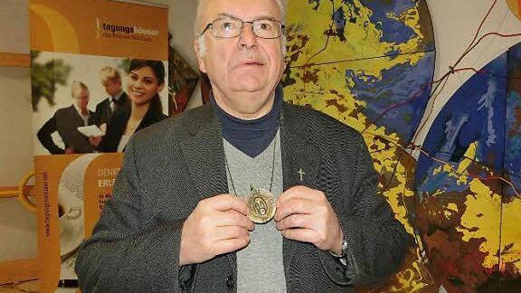 Pallottiner-Pater Gottfried Scheer zeigt das Begleitstück auf seinem Lebensweg: eine Medaille mit dem Gesicht Jesu vom Turiner Grabtuch. Der Geistliche, der aus Oberfranken stammt, erläuterte im Familienbildungshaus St. Michael von Bad Königshofen sein frankenweites Vortragsprogramm.  Foto: Josef Kleinhenz