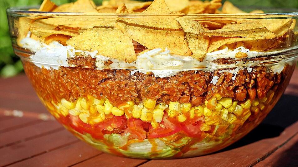 Der Taco-Schichtsalat ist eine beliebte Variante Der Taco-Schichtsalat ist eine beliebte Variante