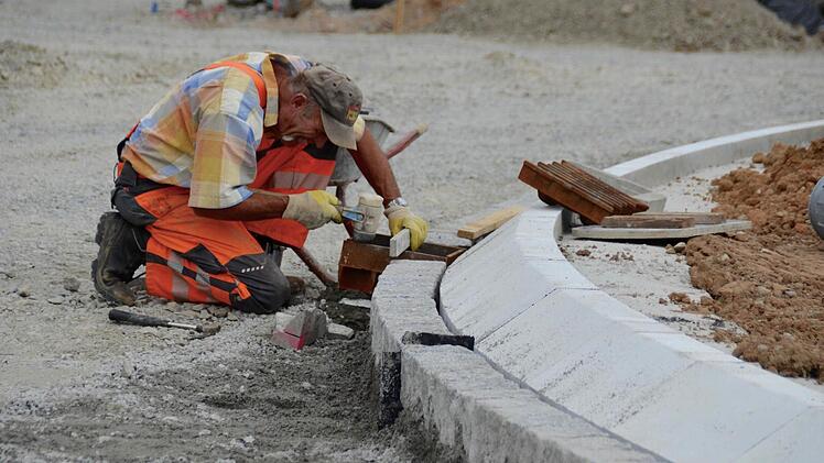 Ein Straßenbauer ist hier dabei, einen Straßeneinlauf einzurichten. Foto: Kathrin Kupka-Hahn