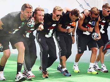 Roman Weidenfeller, Shkodran Mustafi, André Schürrle, Miroslav Klose, Mario Götze und Toni Kroos machen den "Gaucho-Dance". An der kleinen Vorführung scheiden sich die Geister. Foto: Alex Grimm/dpa