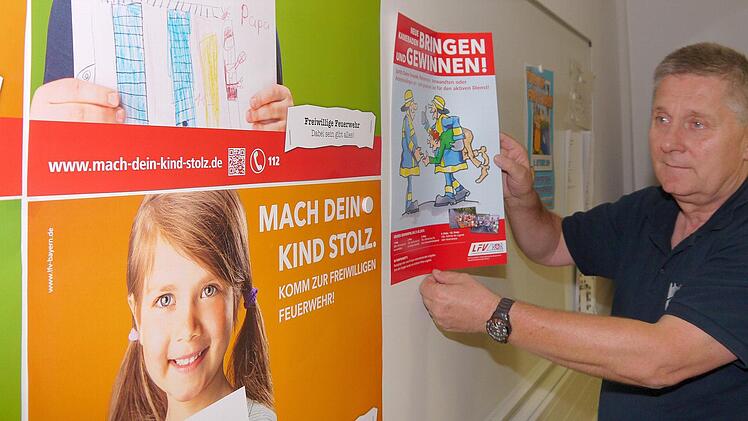 icht nur mit Plakaten, die hier Kreisbrandrat Manfred Lorenz sichtet, sondern auch mit öffentlichen Übungen und Informationsständen wollen die Feuerwehren bei ihrer Aktionswoche die 20- bis 40-Jährigen ansprechen. Fotos: Berthold Köhler