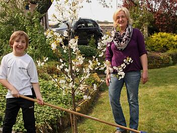Diana Stark-Heil mit ihrem Sohn Paul im blühenden Garten bei einer Edelkirsche. Fotos: Günther geiling