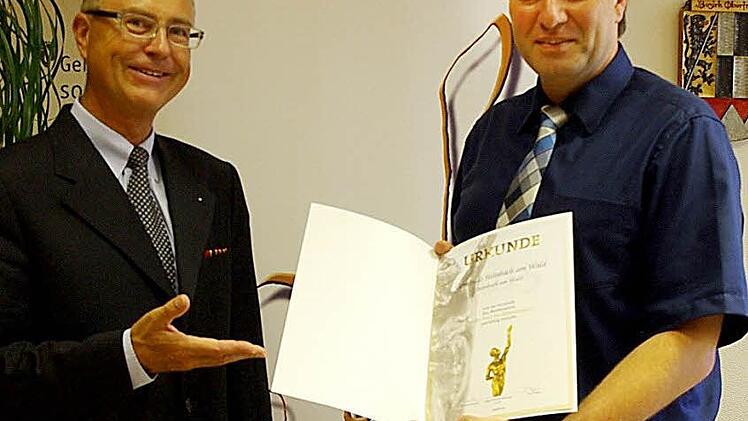 Am Mittwoch händigte (von links) Robert Knitt an Bürgermeister Klaus Löffler die Urkunde für das Erreichen der sogenannten Jurystufe aus. Foto: Heike Schülein