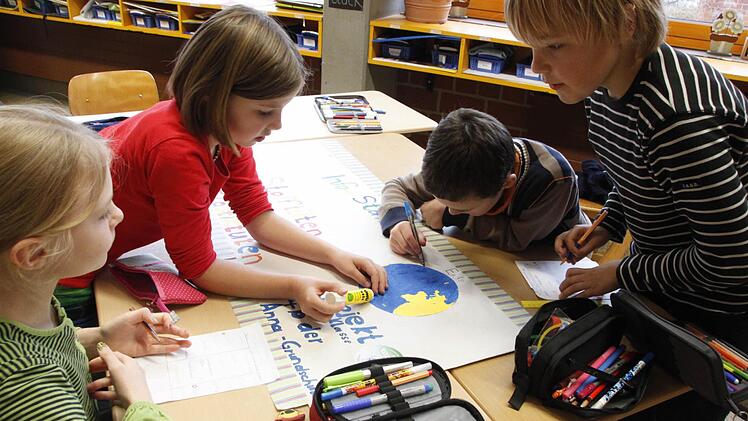 Mit selbst gestalteten Plakaten weisen die Anna-Grundschüler der Klasse 4b eindringlich auf den Umweltschutz hin. Foto: Jennifer Hauser