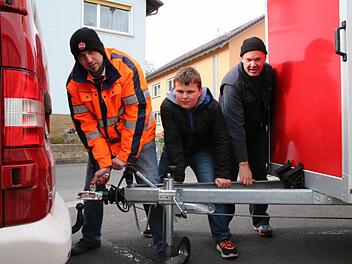 Wenn die Kleinbracher Feuerwehr zum Löscheinsatz ausrückt, muss sie erst den eineinhalb Tonnen schweren Anhänger ankuppeln. Das führen hier (von links) Philipp Schlereth, Louis Pörtner und Christoph Kreps vor. Foto: Ralf Ruppert