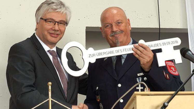 Bürgermeister Rüdiger Gerst (l) übergibt den symbolischen Schlüssel an Kommandant Bernhard Gries.