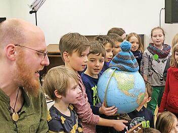 Carlo Hilsdorf spielte auf der Gitarre und sang mit den Kindern der Grundschule Hammelburg. Sie erfuhren viel darüber, wie sie mit ihrem Verhalten die Umwelt schützen können. Foto: Gerd Schaar