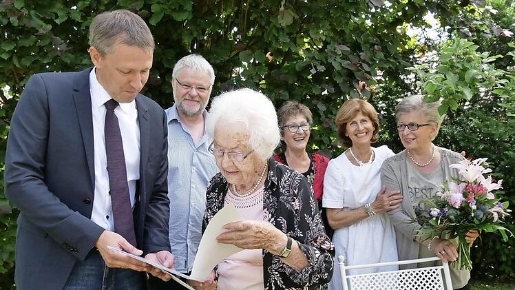 Rödentals Bürgermeister Marco Steiner bringt Erika Sauer die Glückwünsche der Stadt und die Gratulation des bayerischen Ministerpräsidenten Markus Söder. Die Kinder Georg, Anne-Brigitte, Jutta und Heidi (von links) zeigen sich beeindruckt.  Foto: Manja von Nida