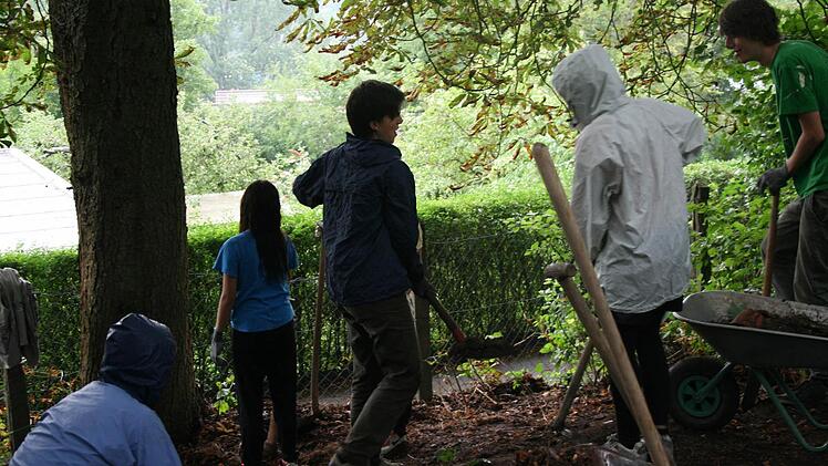 Die Teilnehmer graben einen neuen, barrierefreien Graben.